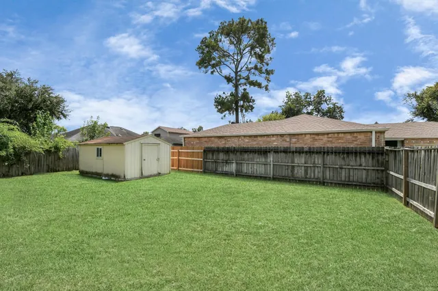 an aerial view of a house with a yard basket ball court and outdoor seating