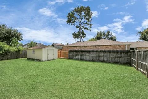 a house with green field in front of it