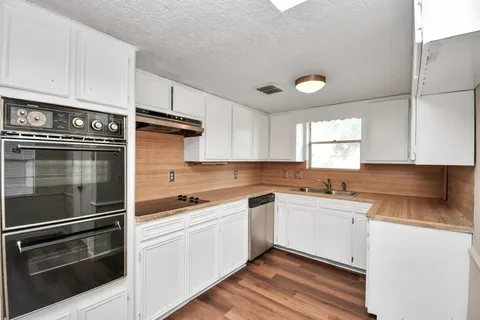 a kitchen with a sink and cabinets