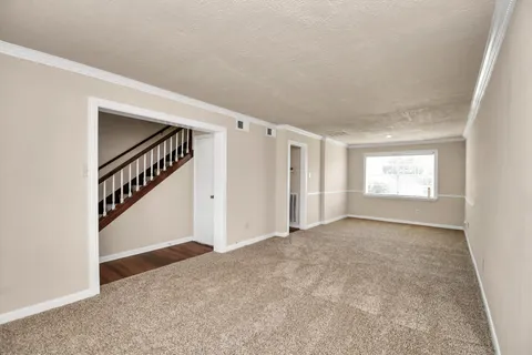 a view of an empty room with stairs
