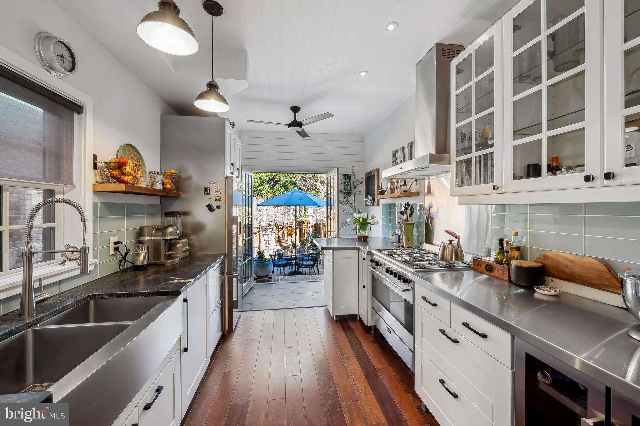 609 South Sharp Street Baltimore, MD 21230 - Photo 14 of 51 a kitchen with stainless steel appliances a sink stove and cabinets