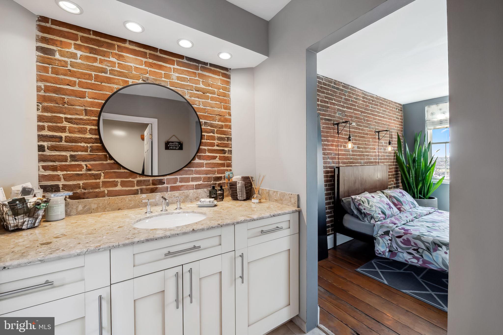 609 South Sharp Street Baltimore, MD 21230 - Photo 23 of 51 a en suite bathroom with a double vanity sink and a mirror