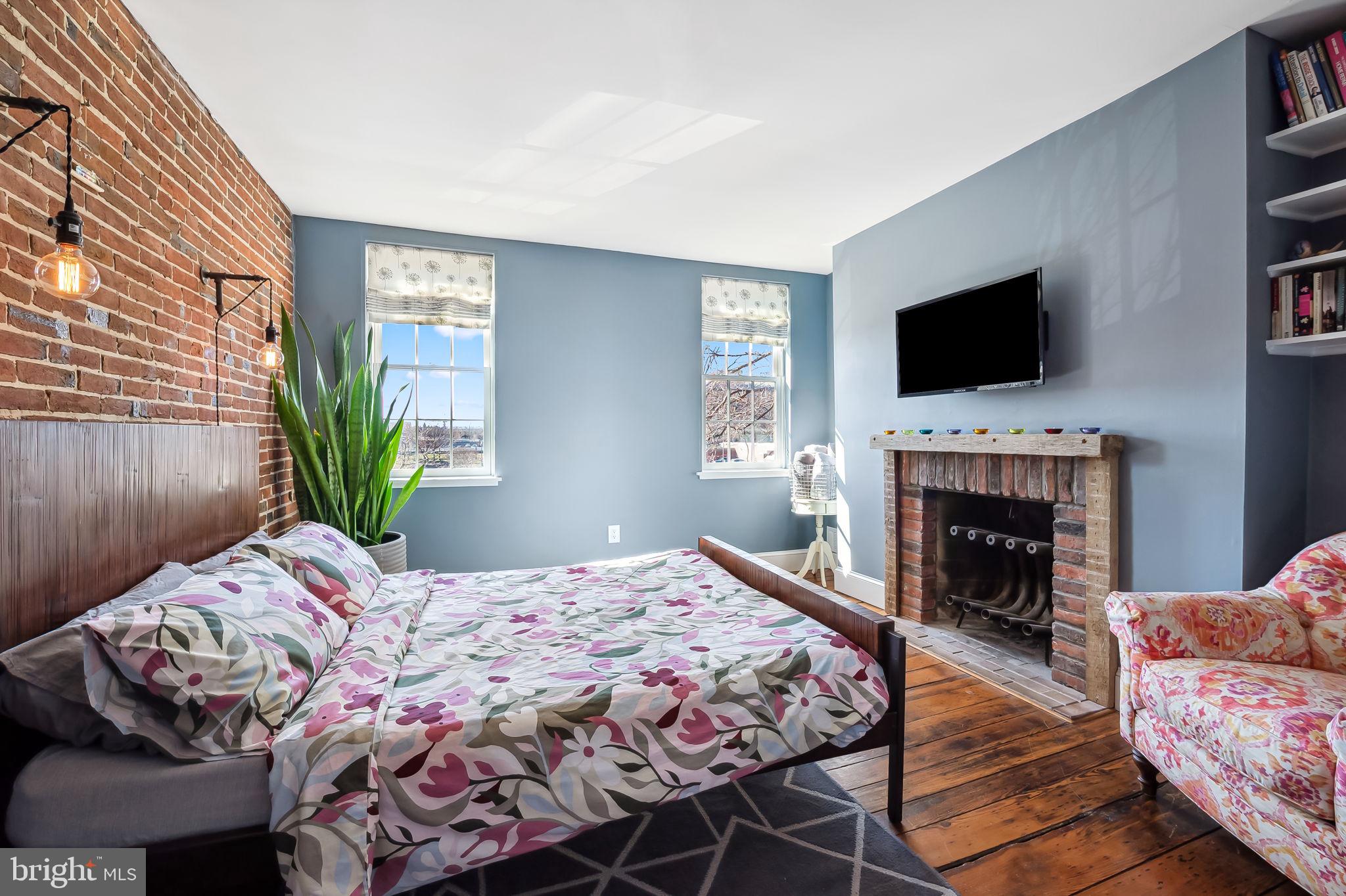 609 South Sharp Street Baltimore, MD 21230 - Photo 24 of 51 a bedroom with a bed and a fireplace