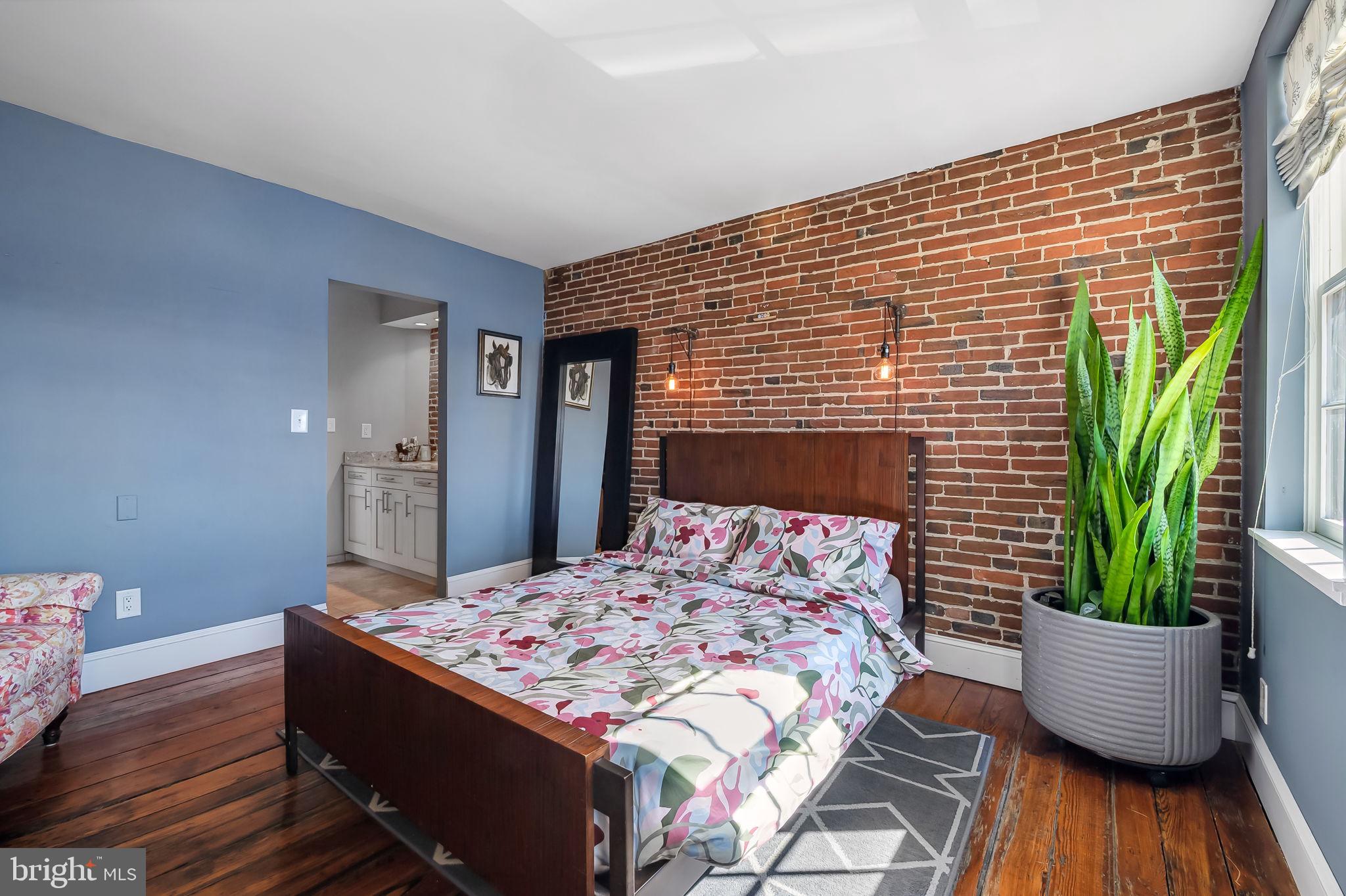 609 South Sharp Street Baltimore, MD 21230 - Photo 25 of 51 a bedroom with a bed and a potted plant