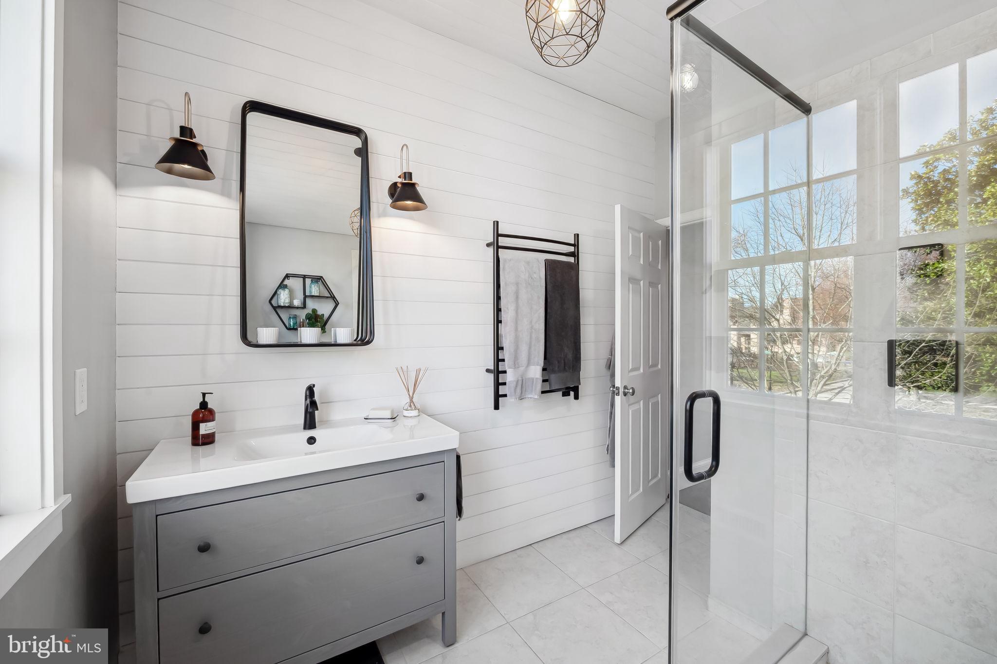 609 South Sharp Street Baltimore, MD 21230 - Photo 28 of 51 a bathroom with a sink mirror and shower