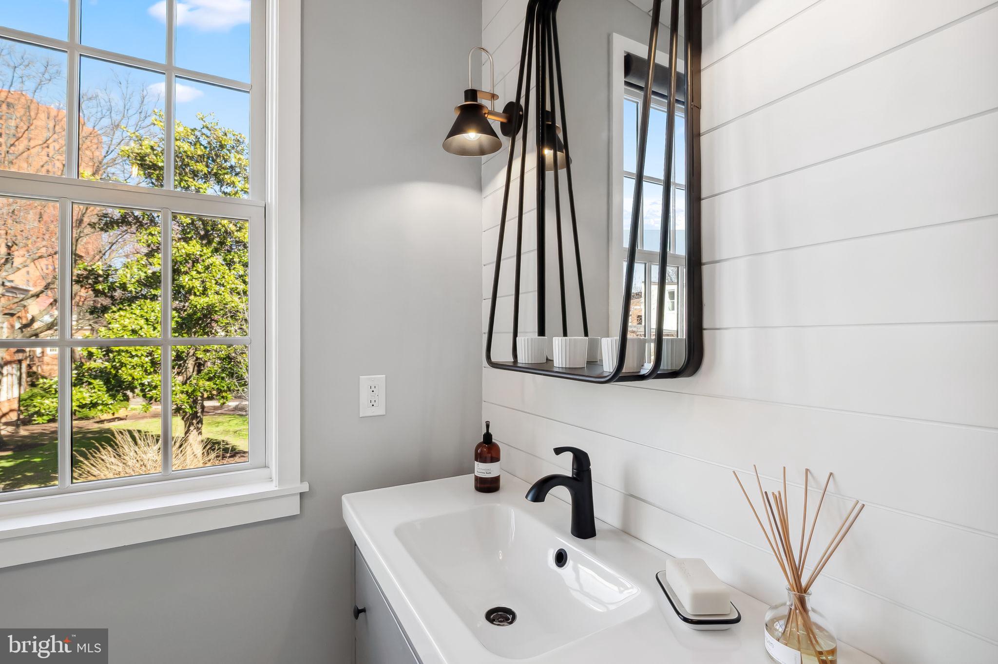 609 South Sharp Street Baltimore, MD 21230 - Photo 31 of 51 a bathroom with a sink and a mirror