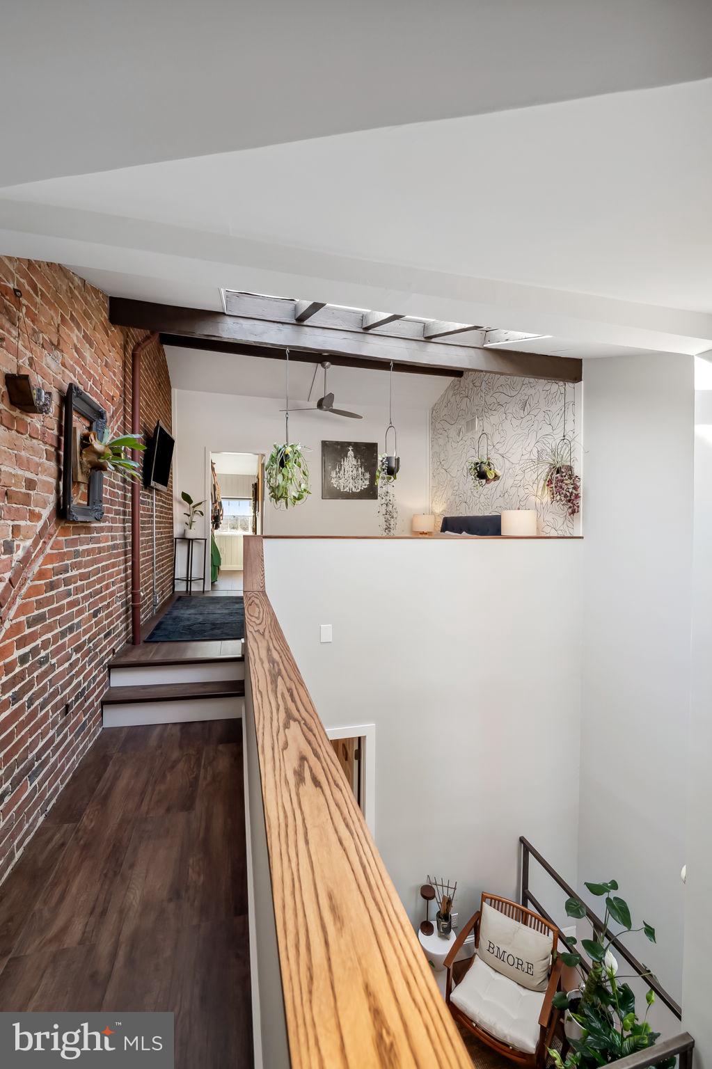 609 South Sharp Street Baltimore, MD 21230 - Photo 42 of 51 a kitchen with kitchen island a stove and wooden floor