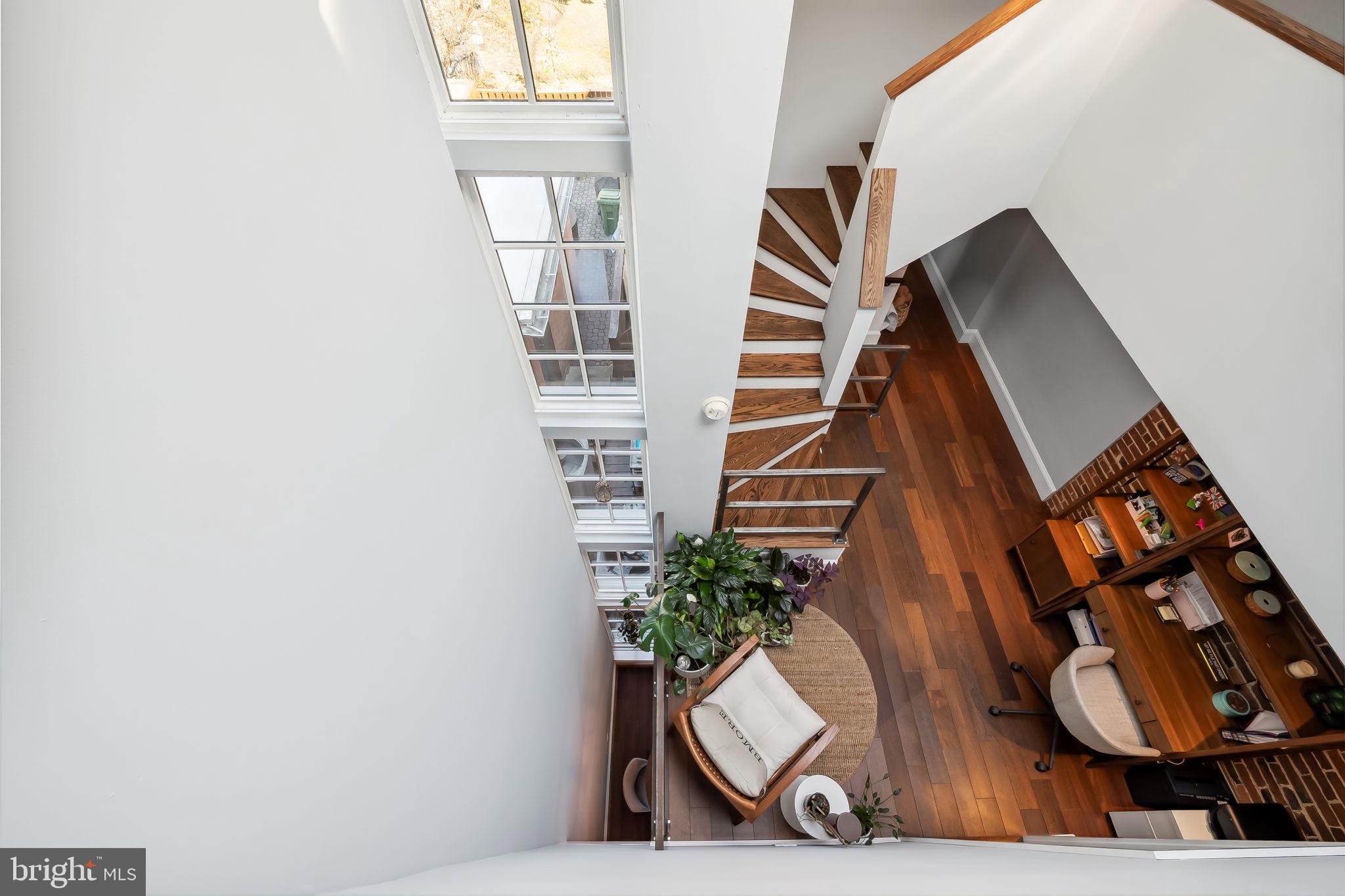 609 South Sharp Street Baltimore, MD 21230 - Photo 43 of 51 a view of staircase with wooden floor and a potted plant