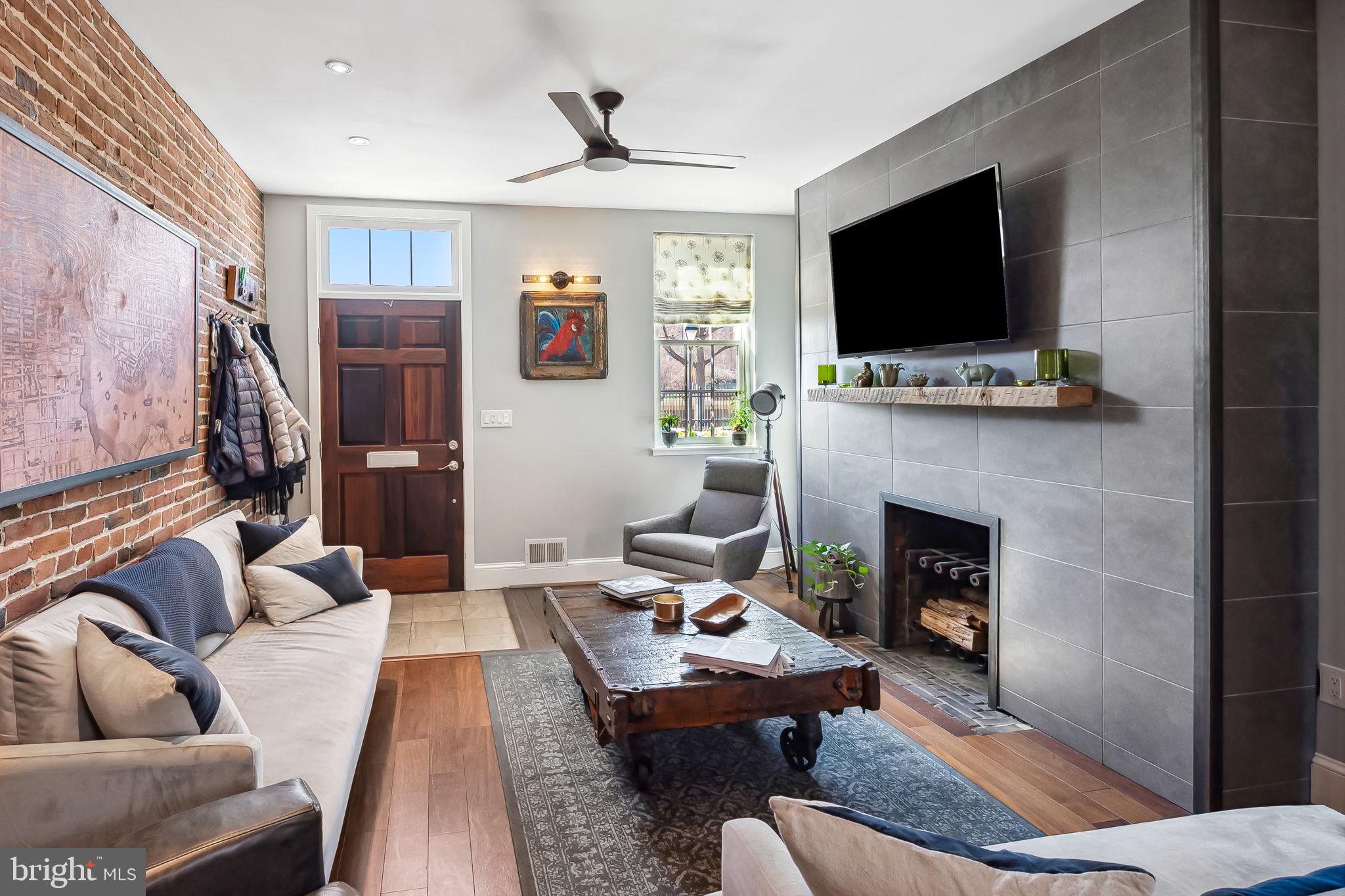 609 South Sharp Street Baltimore, MD 21230 - Photo 5 of 51 a living room with furniture a flat screen tv and a fireplace
