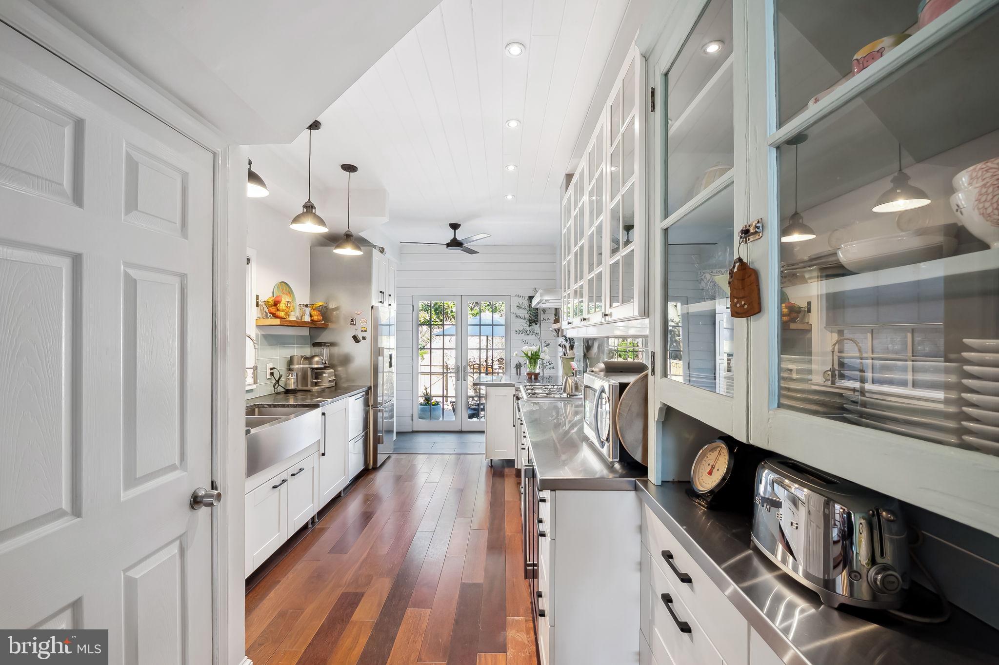 609 South Sharp Street Baltimore, MD 21230 - Photo 10 of 51 a kitchen with stainless steel appliances kitchen island wooden floors and view