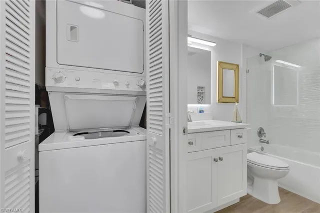 a view of bathroom with a sink a toilet and a mirror