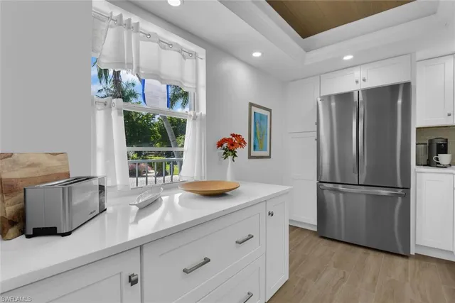 a kitchen with stainless steel appliances granite countertop a refrigerator a sink and a stove