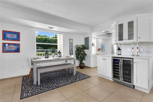 a kitchen with stainless steel appliances kitchen island granite countertop a stove a sink and a refrigerator