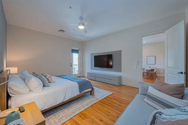 a bedroom with a bed and wooden floor