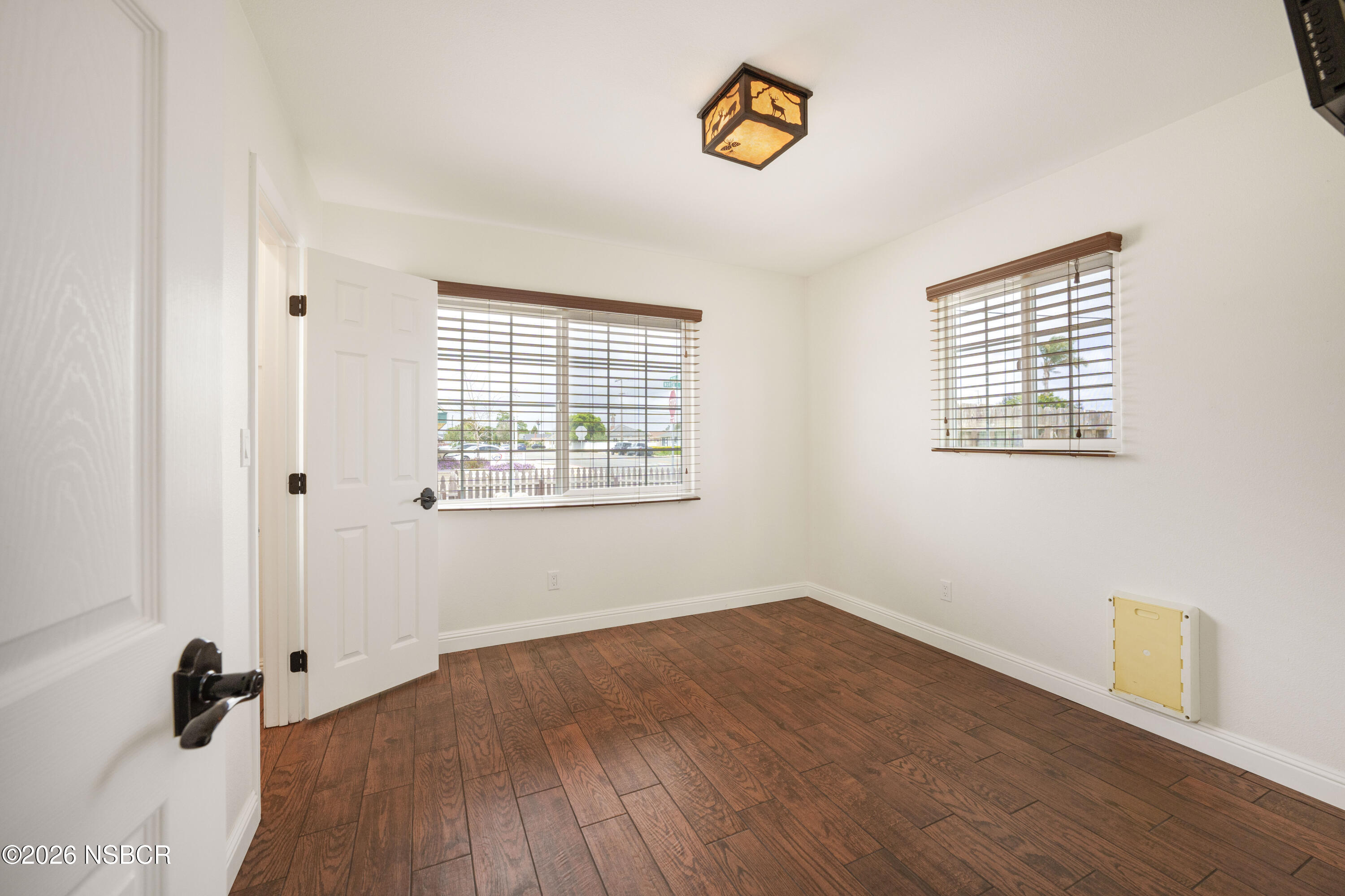 138 North E Street Lompoc, CA 93436 - Photo 19 of 35 an empty room with a window and wooden floor