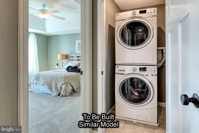 a view of a bedroom with washer and dryer