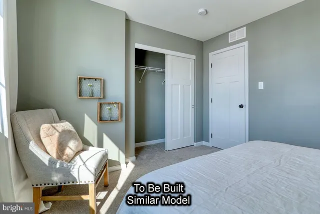 a bedroom with a bed and a chair