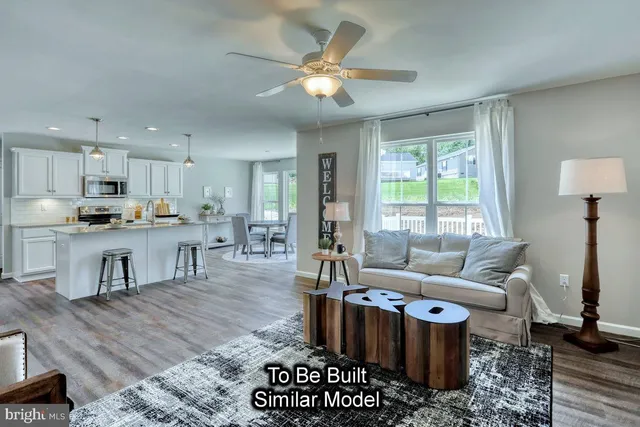 a living room with furniture and kitchen view
