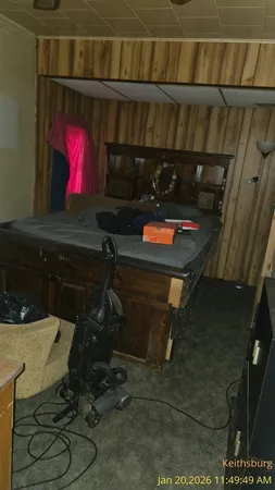 a room with water heater and a wooden cabinets