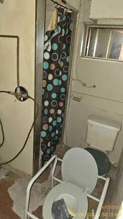 a bathroom with a toilet mirror