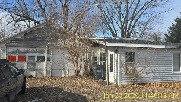 a view of a house with a large tree