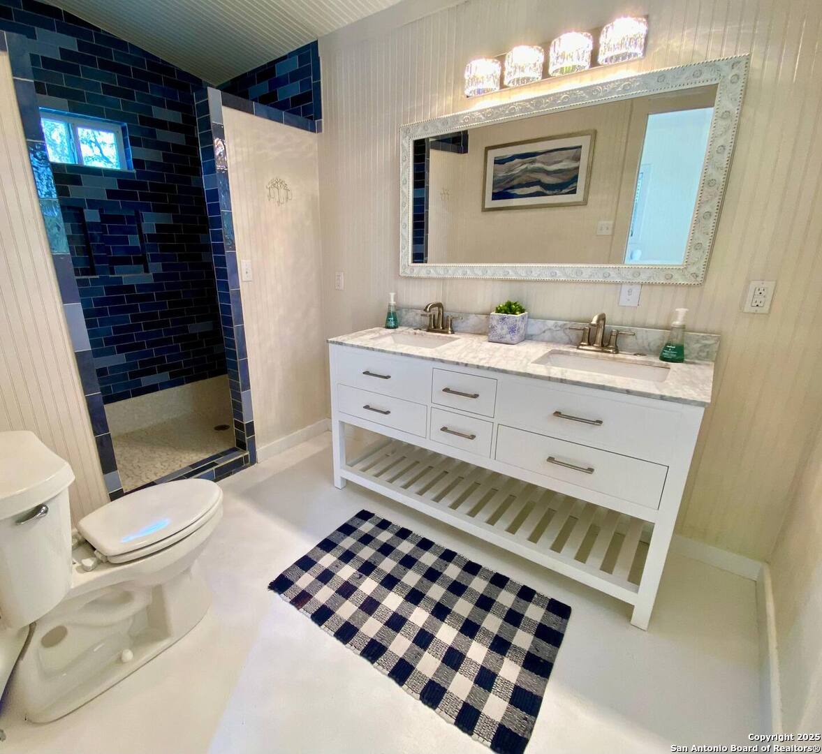 512 County Road 348 Concan, TX 78838 - Photo 28 of 39 a bathroom with a sink a toilet a mirror and shower