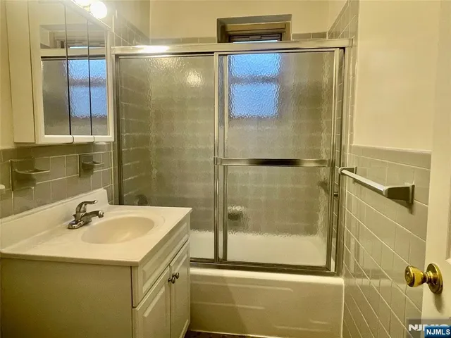 a bathroom with a shower and a sink