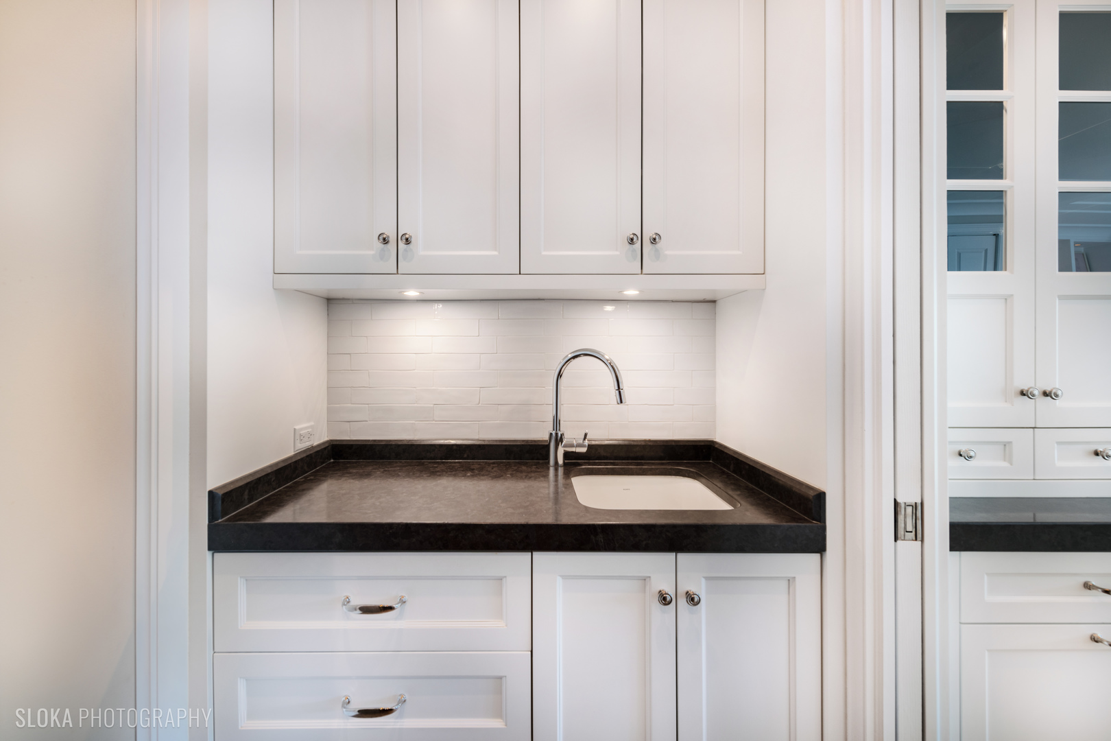 1942 North Sedgwick Street, Unit PH Chicago, IL 60614 - Photo 15 of 84 a kitchen with granite countertop white cabinets and sink