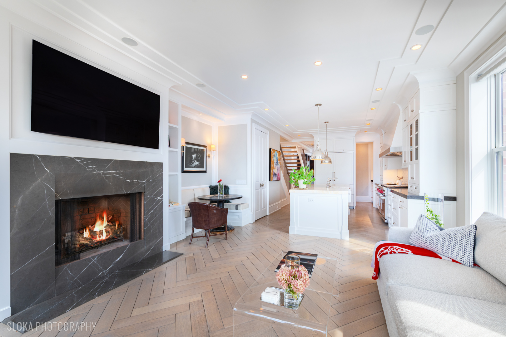 1942 North Sedgwick Street, Unit PH Chicago, IL 60614 - Photo 8 of 84 a living room with furniture a flat screen tv and a fireplace