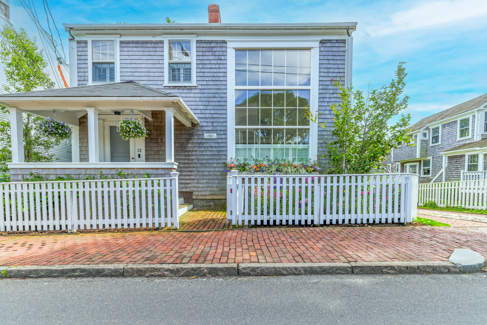 12 Hussey Street Nantucket, MA 02554 - Photo 44 of 47 a front view of a house with a garden