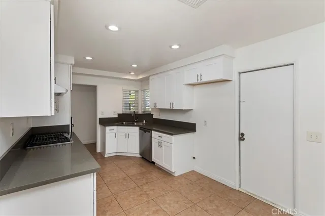 a kitchen with a sink a stove and refrigerator