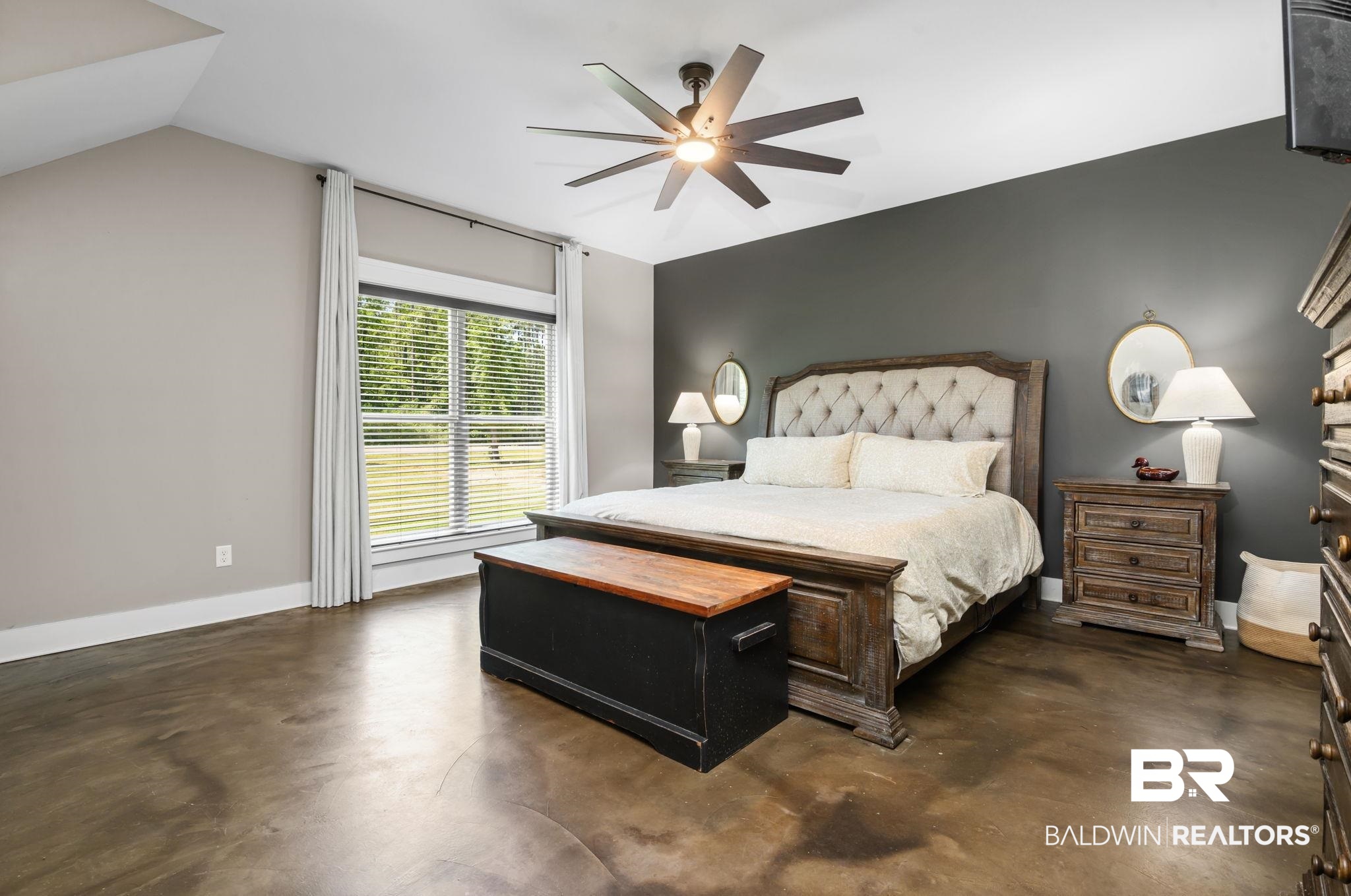 11025 Creax Road Axis, AL 36505 - Photo 21 of 45 Spacious bedroom featuring concrete-finish flooring, a large window with blinds, and a ceiling fan with integrated lighting