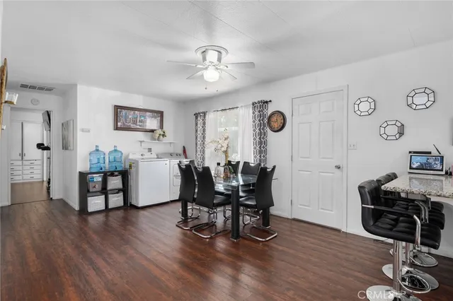 a view of a dining room with furniture and a window