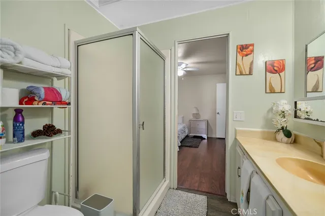 a bedroom with a large bed and ceiling fan