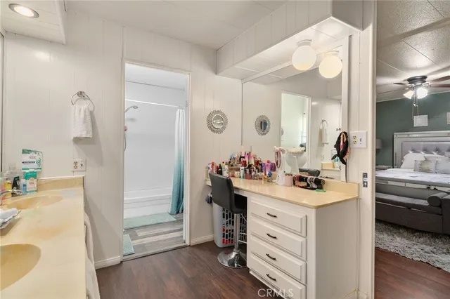a large white kitchen with lots of counter space a sink and stainless steel appliances