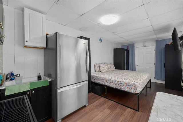 a kitchen with stainless steel appliances a refrigerator and a cabinets