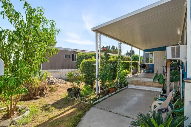 a view of a house with backyard and sitting area