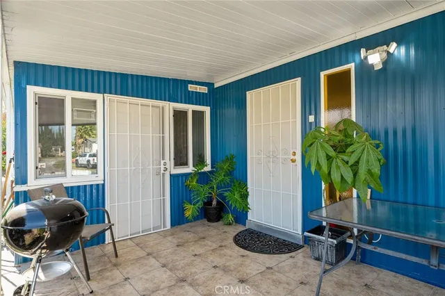 a living room with furniture flat screen tv and wooden floor