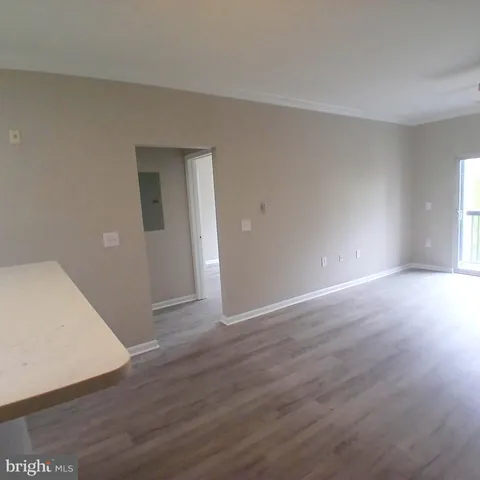 a view of an empty room with wooden floor
