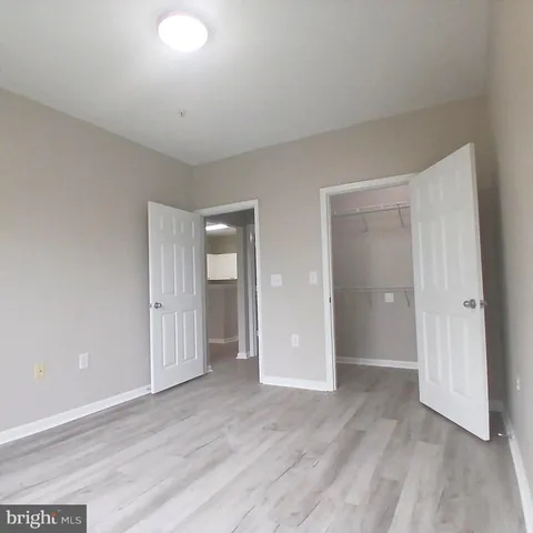 a view of wooden floor and windows in a room