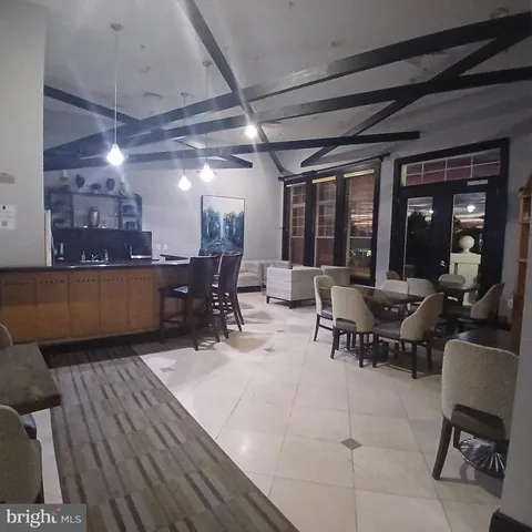 a living room with furniture a air conditioner and a window