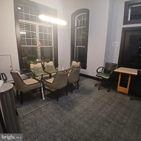 a room with a tv and wooden floor