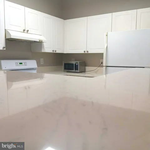 a white refrigerator freezer sitting inside of a kitchen