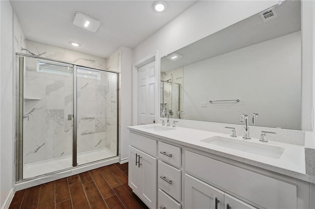 806 Pepperbark Loop Buda, TX 78610 - Photo 21 of 39 a spacious bathroom with a shower sink and mirror