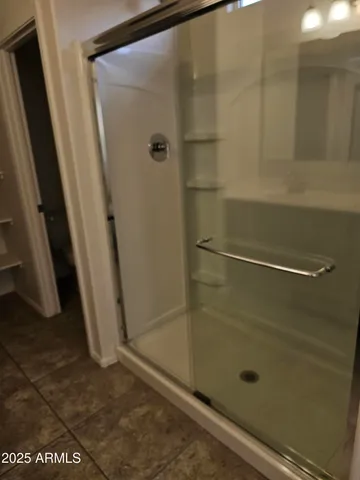 a bathroom with a glass door shower
