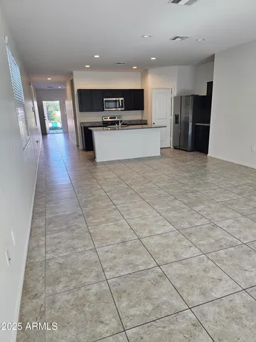 a large kitchen with stainless steel appliances lots of counter space and cabinets