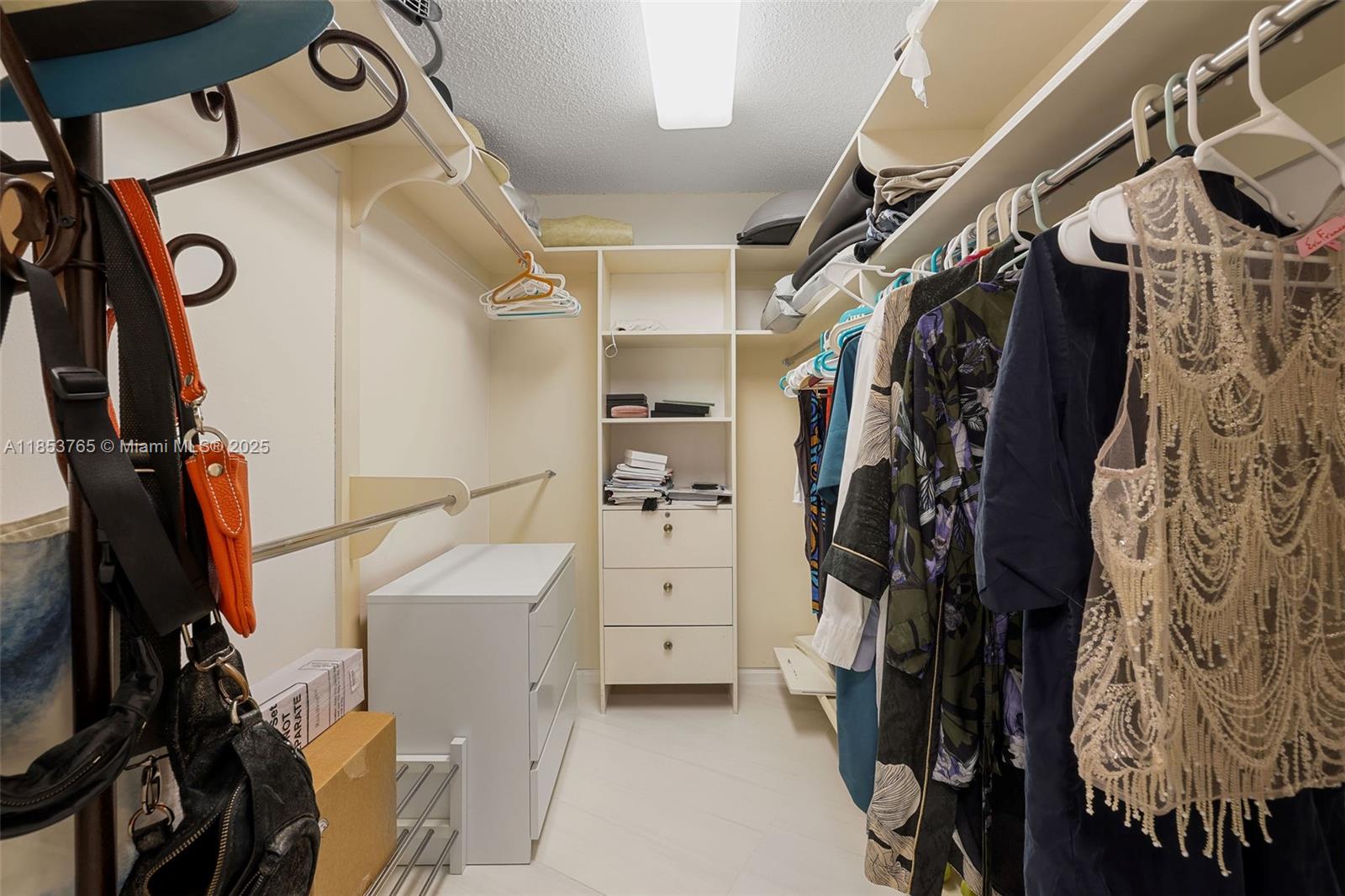 1121 Crandon Boulevard, Unit E802 Key Biscayne, FL 33149 - Photo 18 of 31 a view of walk in closet with clothes and shoes