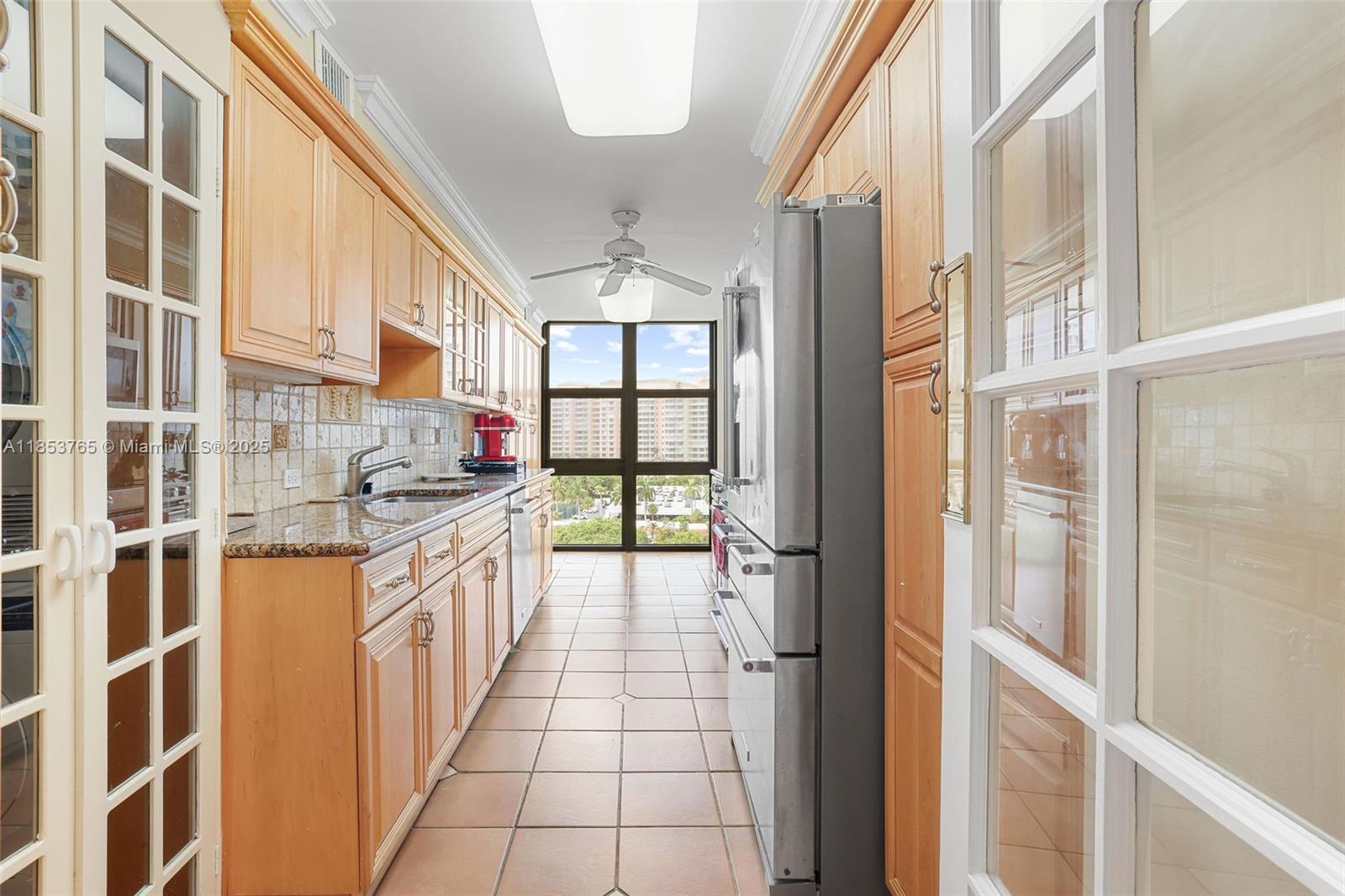 1121 Crandon Boulevard, Unit E802 Key Biscayne, FL 33149 - Photo 10 of 31 a kitchen with stainless steel appliances granite countertop a stove and a refrigerator