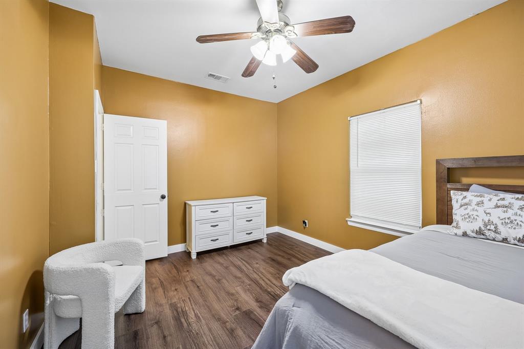 331 Radecke Road Krum, TX 76249 - Photo 30 of 40 Wood-finish flooring with a ceiling fan light fixture
