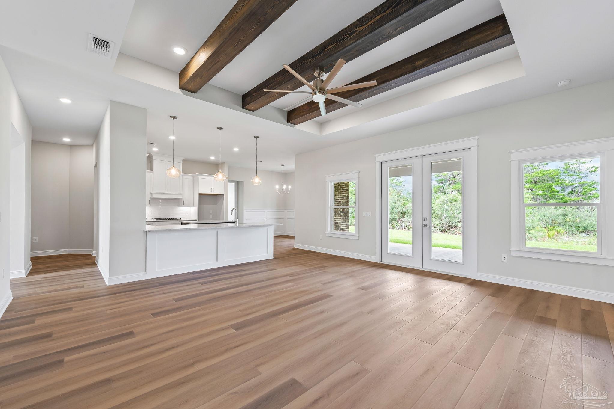 2038 Fontainebleau Court Navarre, FL 32566 - Photo 2 of 8 a view of an empty room with wooden floor and a window